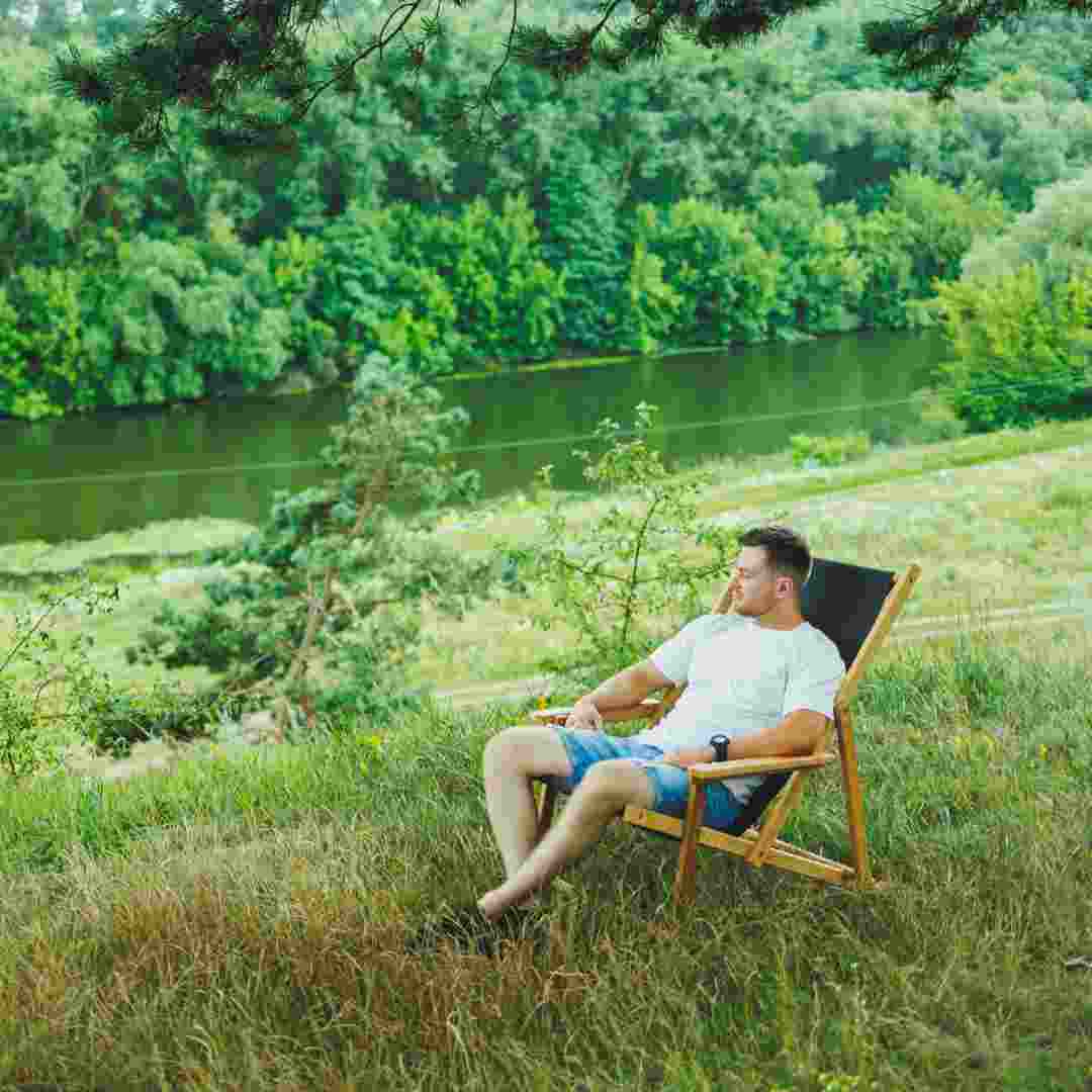 handsome-man-sitting-on-a-wooden-chair-in-nature-a-2025-08-27-08-29-57-utc (1)